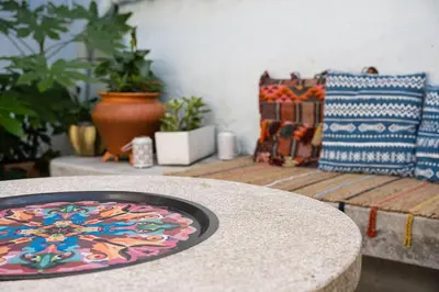 a table with a plate on top of a table at Hidden Gem near city center- garden, outdoor kitchen, sauna in Porto