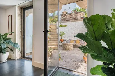 a glass door with a view of a patio at Hidden Gem near city center- garden, outdoor kitchen, sauna in Porto