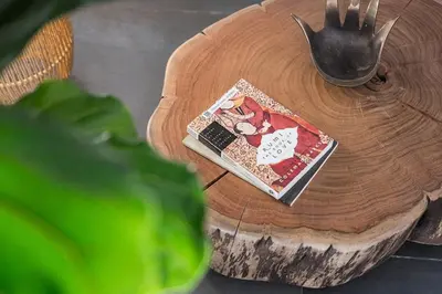 a book on a wooden table with a fork at Hidden Gem near city center- garden, outdoor kitchen, sauna in Porto