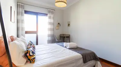 a bedroom with a large white bed with pillows at Porto Essence Apartment in Porto