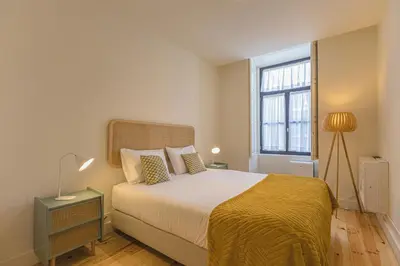 a bedroom with a large bed and a window at Firmeza Gardens in Porto