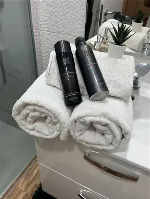 a pile of towels and a blow dryer on a bathroom counter at Apartamento centro histórico Porto in Porto