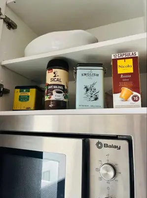 a refrigerator shelf with food items on it at Apartamento centro histórico Porto in Porto