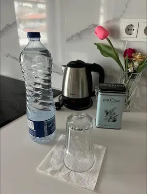 a bottle of water and a glass on a counter at Apartamento centro histórico Porto in Porto