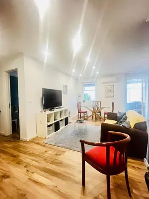 a living room with a couch and a red chair at Apartamento centro histórico Porto in Porto
