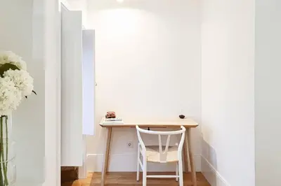 a wooden table and chairs on a balcony at Great Flat & View in Historic Porto by LovelyStay in Porto