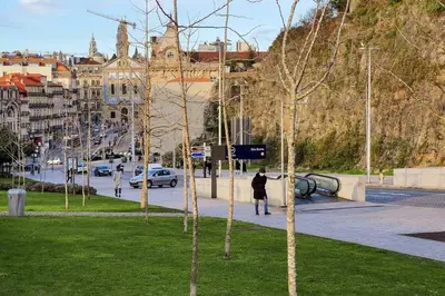 a man walking down a sidewalk in a city at Great Flat & View in Historic Porto by LovelyStay in Porto