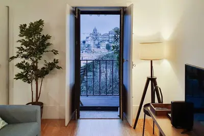 a living room with a blue couch and a table at Great Flat & View in Historic Porto by LovelyStay in Porto