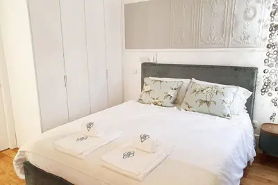 a living room with a couch and a table with a television at Great Flat & View in Historic Porto by LovelyStay in Porto