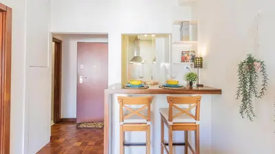 a kitchen with a counter and two stools at Adorable apartment 2D in Porto