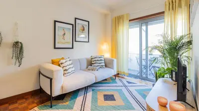 a living room with a couch and a tv at Adorable apartment 2D in Porto