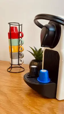 a close up of acomputer with a cup on a table at SM Apartments in Porto