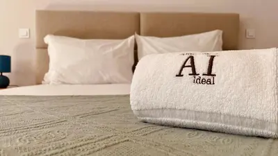 a bed with a pillow with the al label on it at SM Apartments in Porto