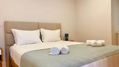 a bedroom with a bed with two towels on it at SM Apartments in Porto