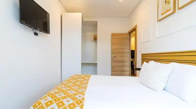 a bedroom with a bed and a flat screen tv at Trendy 2BR Near Douro River by LovelyStay in Vila Nova de Gaia