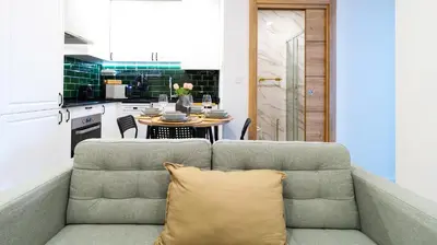 a living room with a couch and a kitchen at Trendy 2BR Near Douro River by LovelyStay in Vila Nova de Gaia