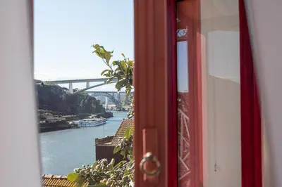 a door with a view of a river and a bridge at GuestReady - Oporto Old Town House 2 in Porto