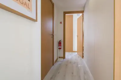 a hallway with a wooden floor and a door at Wonderfull apartment Campanhã Train station with parking in Porto