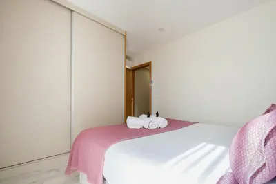 a bedroom with a bed with three towels on it at Wonderfull apartment Campanhã Train station with parking in Porto