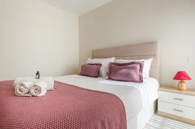 a bedroom with two beds with purple pillows at Wonderfull apartment Campanhã Train station with parking in Porto