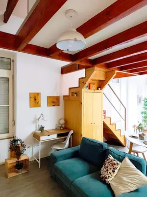 a living room with a table and chairs at Mezzanine with courtyard in Porto in Porto