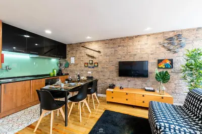 a kitchen and living room with a table and chairs at Merc Porto Downtown's Place in Porto