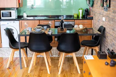 a kitchen with a glass table and four chairs at Merc Porto Downtown's Place in Porto