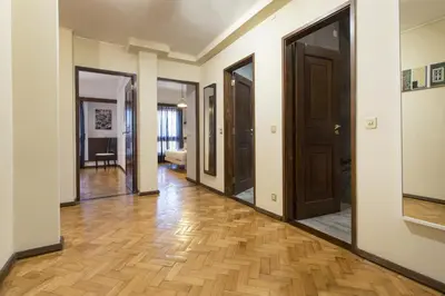 a hallway with several doors and wooden floors at LV Premier Apartments Clerigos-RE2 in Porto