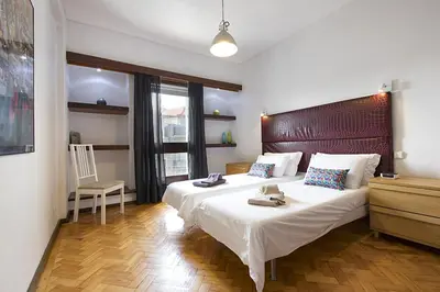 a bedroom with two beds and a wooden floor at LV Premier Apartments Clerigos-RE2 in Porto