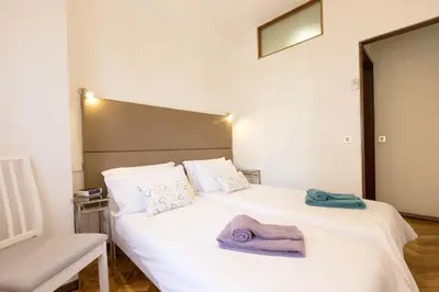a bedroom with a white bed with towels on it at LV Premier Apartments Clerigos-RE2 in Porto