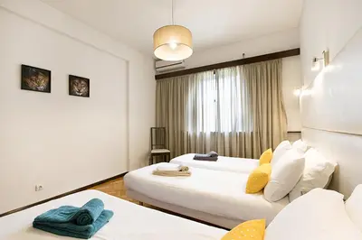 a hotel room with two beds and a window at LV Premier Apartments Clerigos-RE2 in Porto