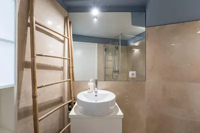 a bathroom with a white sink and a mirror at GuestReady - Souto Downtown Studios in Porto