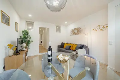a living room with a couch and a glass table at Lapa Stylish Apartments by Vacationy in Porto