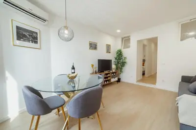 a dining room with a glass table and chairs at Lapa Stylish Apartments by Vacationy in Porto