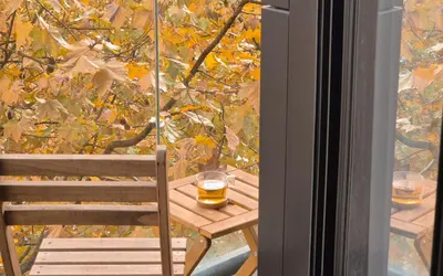 a wooden table with two glasses of beer on a window at Porto Trindade Balcony in Porto