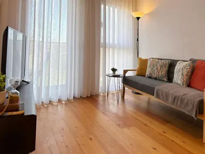 a living room with a couch and a table at Porto Trindade Balcony in Porto