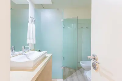 a bathroom with a sink and a toilet at Marilia's Garden Apartment in Porto