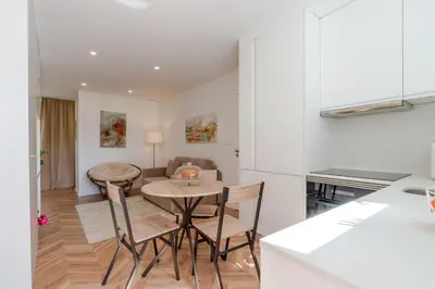 a kitchen and dining room with a table and chairs at Stylish Studio w/ Charming Terrace by HostWise in Porto