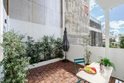 an outdoor patio with a table and an umbrella at Stylish Studio w/ Charming Terrace by HostWise in Porto