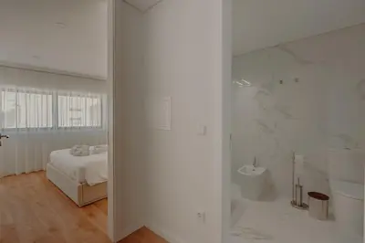 a white kitchen with a window and a staircase at Brand New Musas Ap by Best2Stay in Porto
