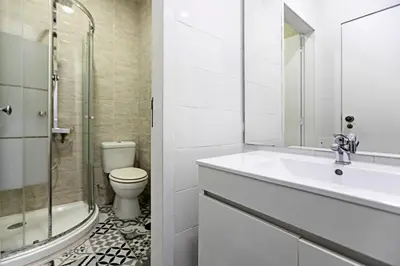 a bathroom with a sink and a toilet and a shower at Coliseu Downtown Loft in Porto