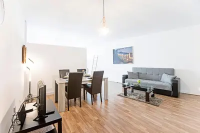 a living room with a table and a couch at Coliseu Downtown Loft in Porto