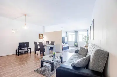 a living room with a couch and a table at Coliseu Downtown Loft in Porto