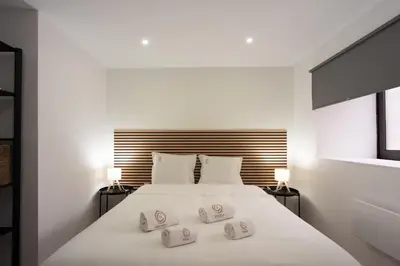 a bedroom with a white bed with three pillows on it at Yellow House by Best2Stay in Vila Nova de Gaia