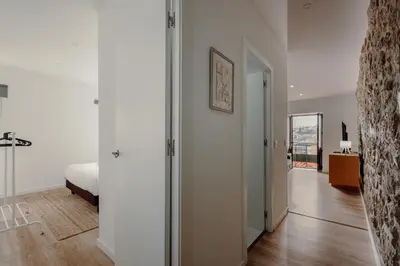 a kitchen with white cabinets and a table at House River View by Best2Stay in Vila Nova de Gaia