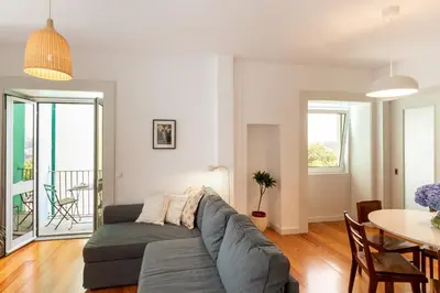 a living room with a couch and a table at A House With A View - 1st floor in Porto