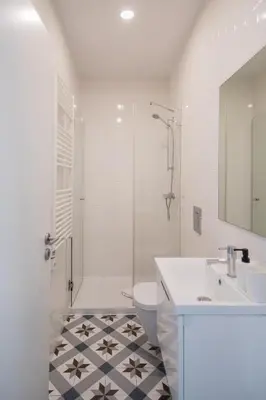 a bathroom with a sink and a toilet and a shower at Downtown Refuge Camões in Porto