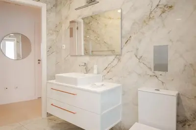 a white bathroom with a sink and a mirror at Family Porto in Porto
