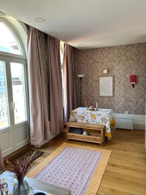 a room with a bed and a table and a window at Lazarus View Apartment in Porto