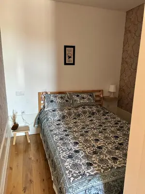 a bedroom with a bed with a blue comforter at Lazarus View Apartment in Porto